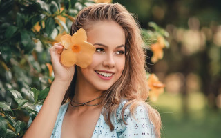 Woman smiling flower outdoors bokeh - a woman holding free wallpaper