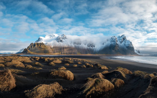 Mountain beach ocean clouds sky - low free wallpaper