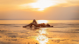 Beach sunset woman crossed legs - the cloud free wallpaper
