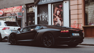 Black sports car parked white - the side of the road free wallpaper