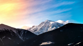 Mountain range snow covered summit - mountain in the background free wallpaper