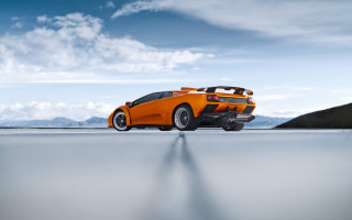 Orange sports car mountains blue - nice free wallpaper