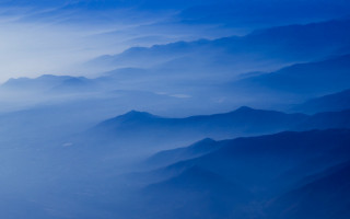 Mountain range airplane window blue 7 - a view of a mountain range free wallpaper
