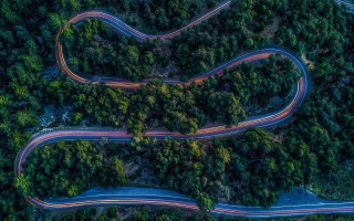 Winding road forest cars nature - 8k artistic photography free wallpaper