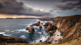 Rocky cliff water cloudy sky 6 - a rocky cliff free wallpaper