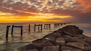 Pier rocky beach sunset boats - a few boat free wallpaper