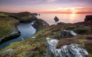 Sunset rocky coastline water forest - a body of water free wallpaper for desktop
