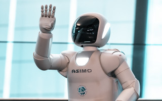 Robot waving building blurry helmet - a building in the background free wallpaper