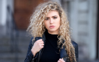 Woman curly hair jacket portrait - a black top free wallpaper