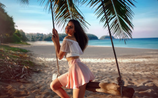 Woman pink skirt swing beach - a palm tree in the background free wallpaper