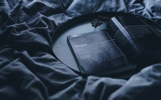 Black book on bed cinematic - a black plate free wallpaper