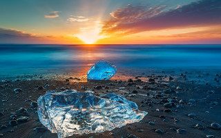 Blue iceberg beach sunset ocean - a sun setting free wallpaper