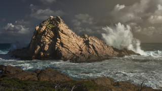 Large rock wave shore cloudy - a large rock free wallpaper