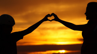Couple holding hands sunset sky - hand free wallpaper