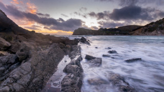 Rocky shore sunset waves mountains - a rocky shore free wallpaper