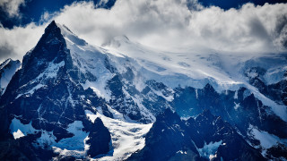 Snowy mountain cloudy sky night - a mountain free wallpaper