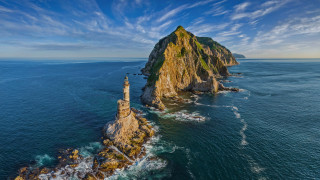 Lighthouse island ocean waves blue - a small island in the middle of the ocean free wallpaper