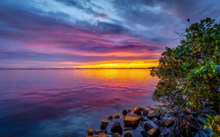 Sunset lake rocks trees clouds 3 - a sunset over a lake free wallpaper