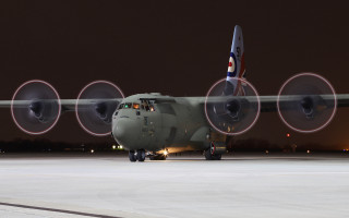 Military plane runway night tiltshift - circle free wallpaper