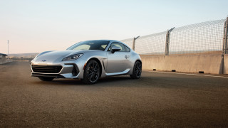 Silver sports car driving fence - a fence and a fenced in area free wallpaper