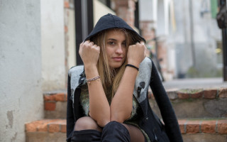 Woman sitting hooded portrait blurry - a hood free wallpaper
