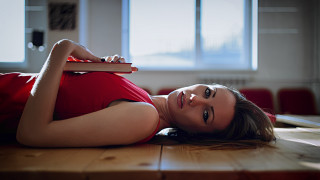 Woman laying on floor with - a window in the background free wallpaper