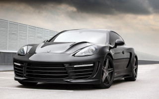 Black sports car parking lot 10 - a parking lot under a cloudy sky free wallpaper