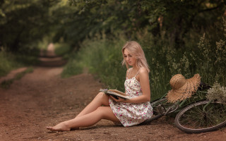Woman reading bicycle flower basket - portrait photography free wallpaper