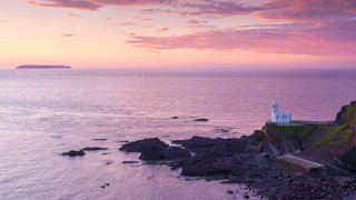 Lighthouse rocky cliff ocean sunset 12 - a rocky cliff free wallpaper