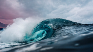 Large wave breaking ocean mountains - cloudy free wallpaper