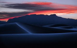 Sunset mountain range sand dunes - a sunset over a mountain range free wallpaper