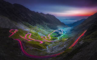 Winding road mountains night light - a colorful light free wallpaper