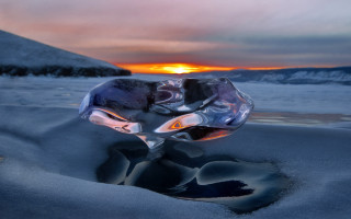 Glass sculpture snow mountain ocean - a mountain in the background and a body of water free wallpaper
