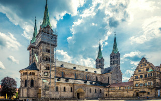 Romanesque neo gothic clock tower - a cloudy sky behind free wallpaper