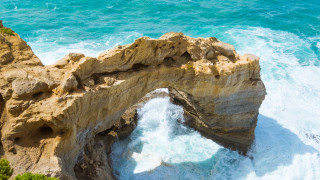 Rock formation water cliff beach - a body of water below free wallpaper