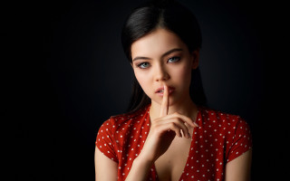 Woman red polka dot shushing - her finger free wallpaper