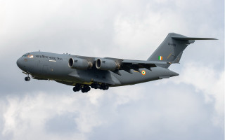Military plane cloudy sky landing - front view free wallpaper