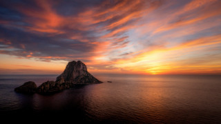 Rock formation ocean sunset colorful - a small island in the middle of the ocean free wallpaper
