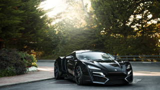Black sports car parked trees - a parking lot next free wallpaper