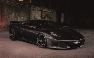 Black sports car night parking 2 - a brick wall behind free wallpaper