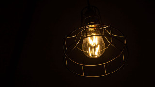 Lit bulb wire cage dark - space free wallpaper
