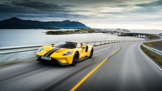 Yellow sports car ocean bridge - a road next free wallpaper