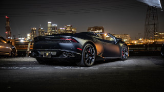 Black sports car night city 5 - a city skyline in the background free wallpaper