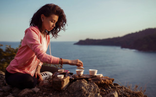 Woman sitting rock tea ocean - daphne mcclure free wallpaper