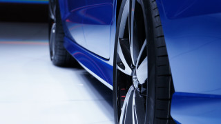 Car tire closeup white floor - a close up of a car tire free wallpaper