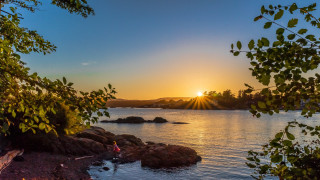 Sunset lake forest shore water - a sunset over a body of water free wallpaper