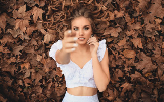 Woman crop top pointing phone - her finger free wallpaper