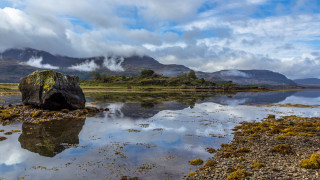 Mountain lake clouds grass sky - a large rock free wallpaper