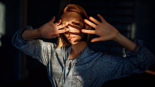 Woman hands up anamorphic flare - a face free wallpaper