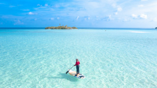 Surfboard ocean island blue sky - a small island in the background free wallpaper